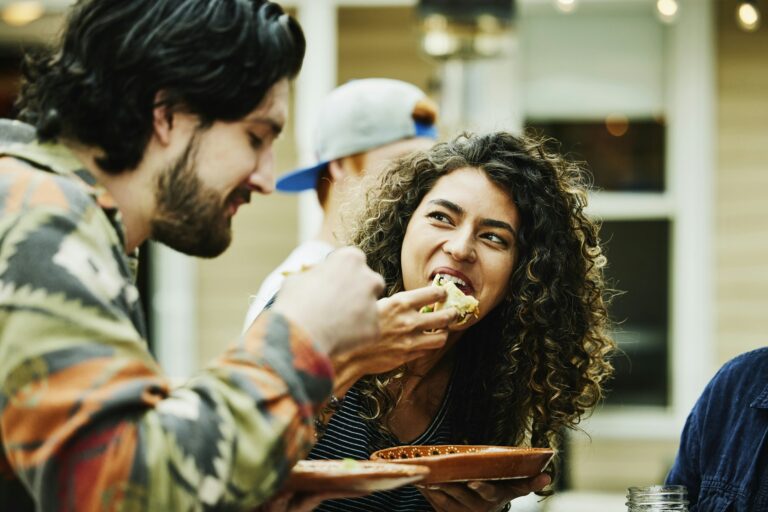 Couple eating food GettyImages 1349860330 RFC